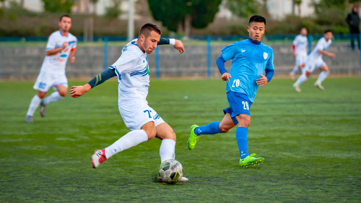 2 men playing soccer