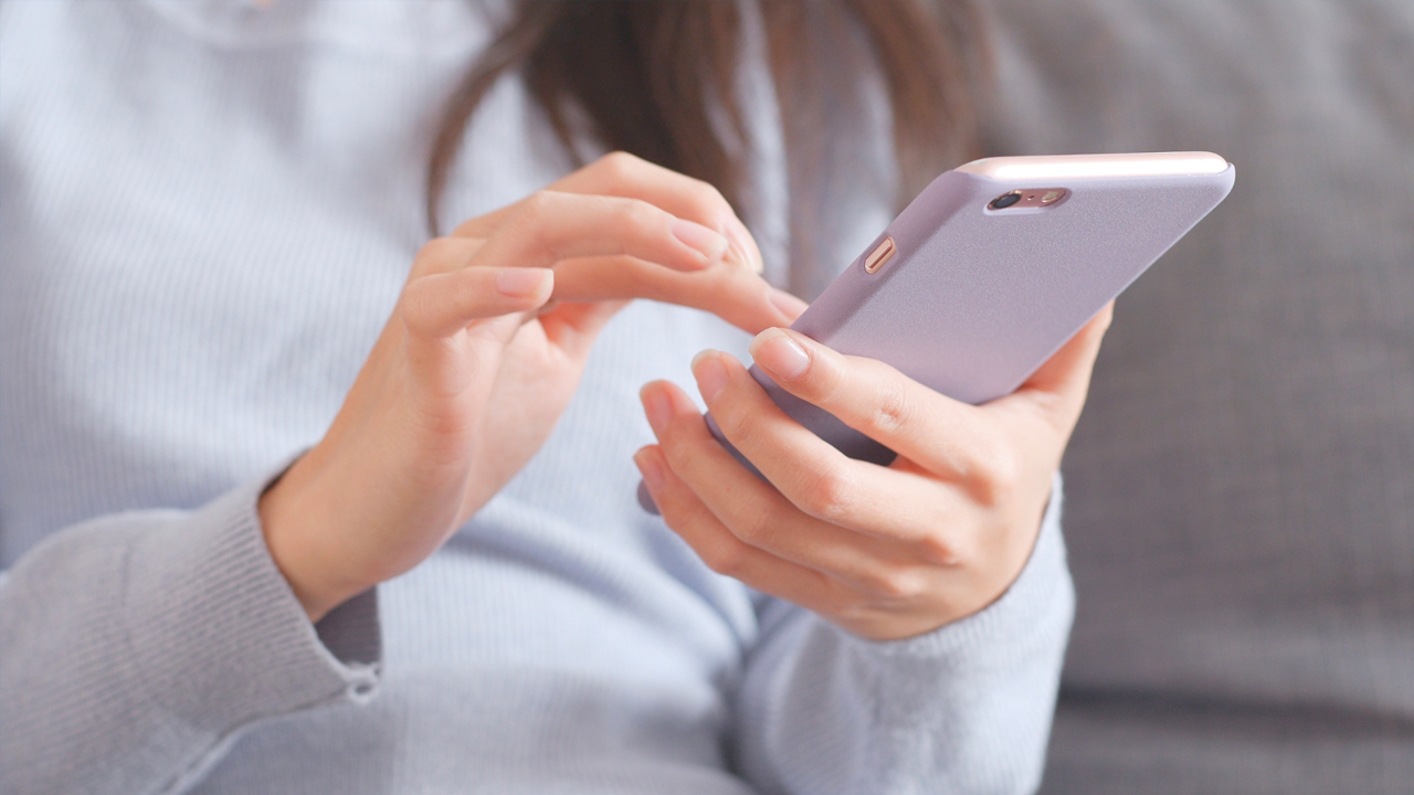 close up of woman using iphone