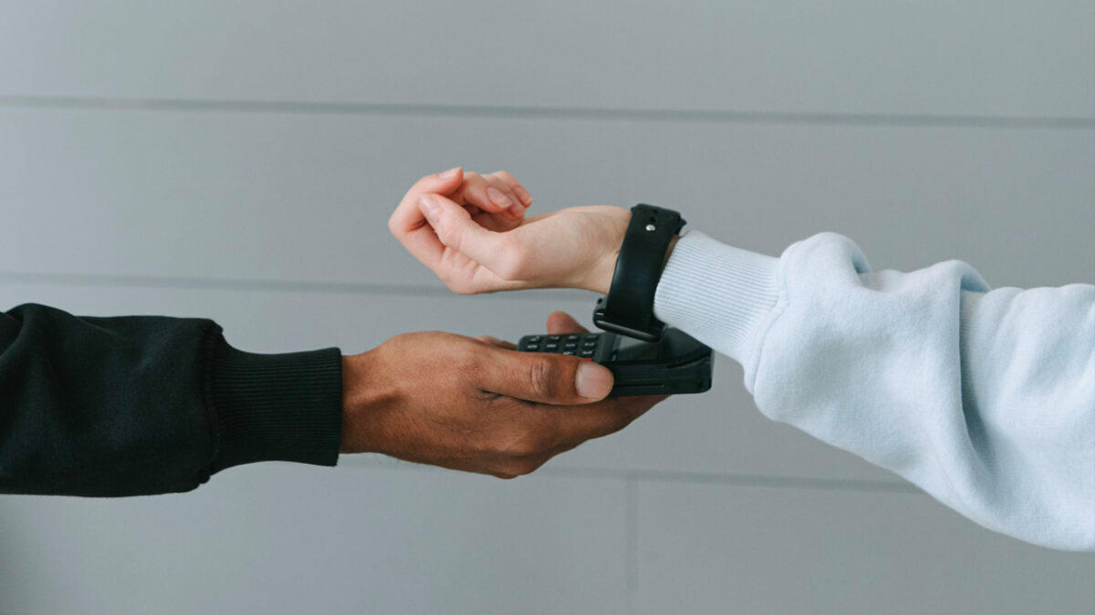 closeup of person paying with their watch