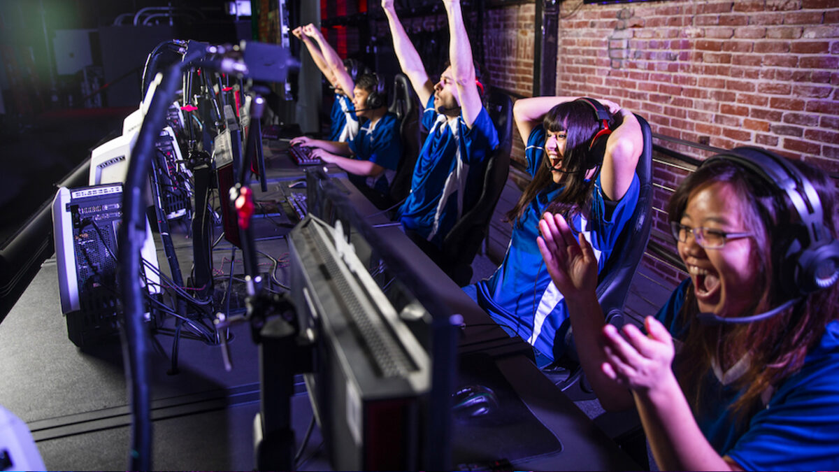 group og yung adults cheer as they game on computers