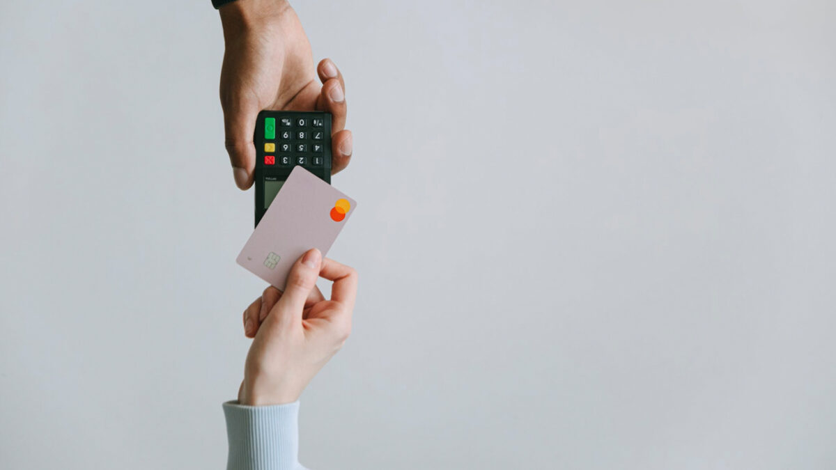 close up of someone paying with tap mastercard