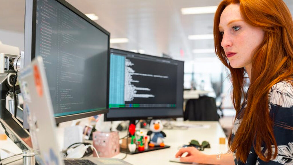 red haired woman coding