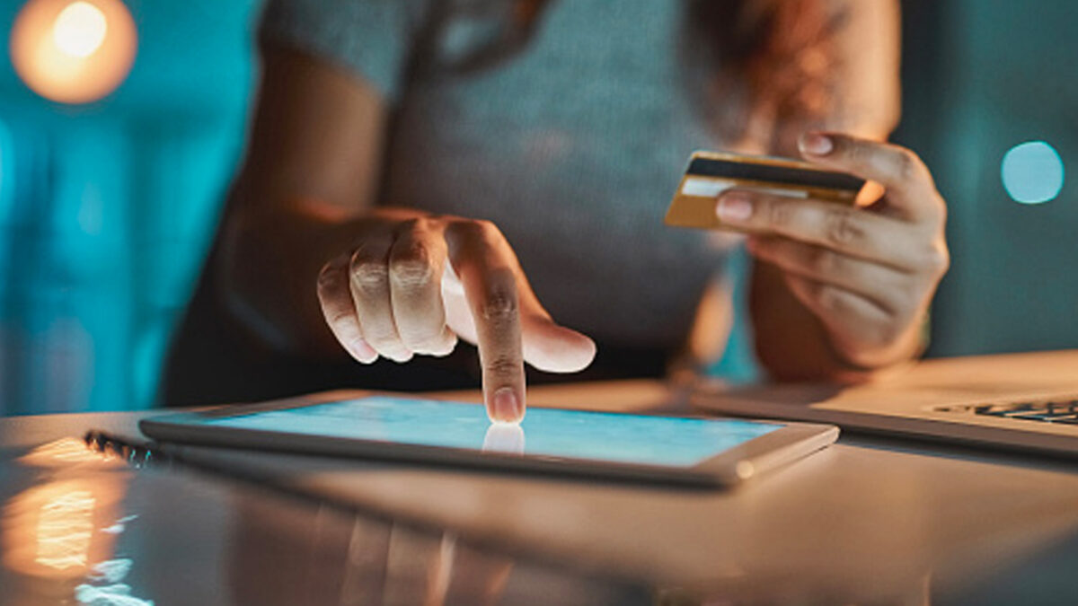 woman paying with card on ipad close up